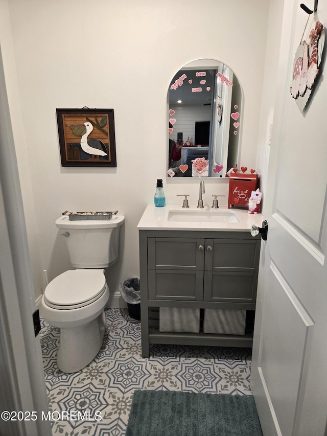 bathroom featuring toilet, tile patterned floors, and vanity