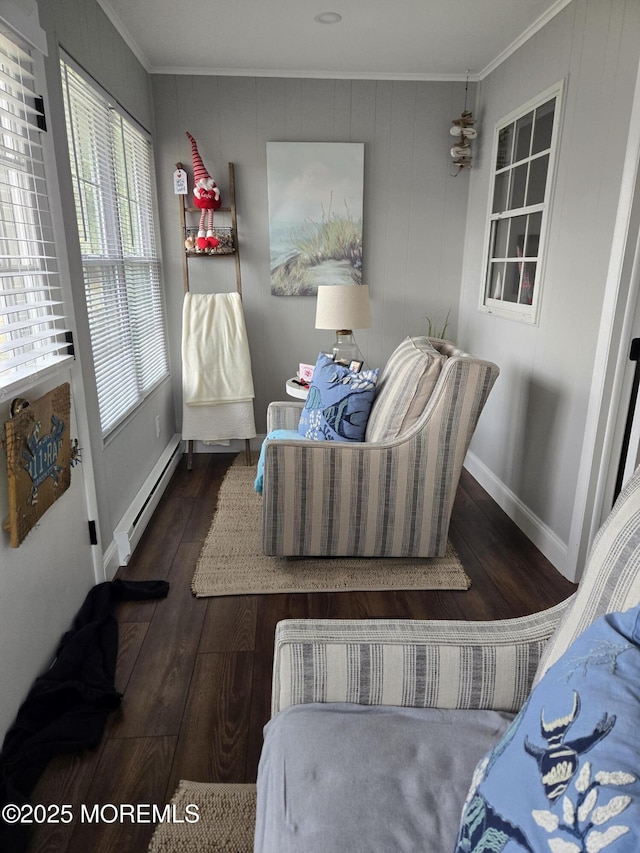 interior space with ornamental molding, baseboard heating, and dark hardwood / wood-style floors