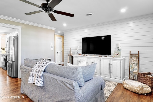 living room featuring crown molding, ceiling fan, and wood-type flooring