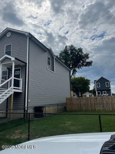 view of side of property with a yard