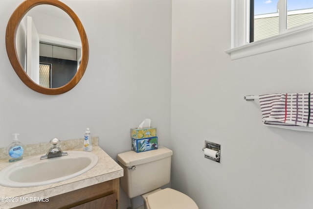 bathroom with toilet and vanity