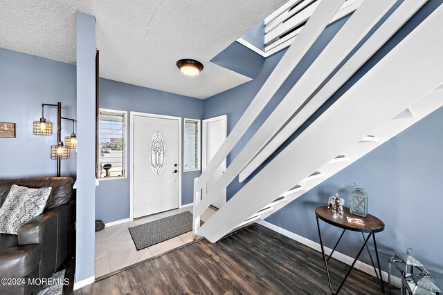 entrance foyer featuring a textured ceiling and hardwood / wood-style floors