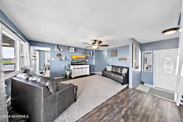 living room featuring a textured ceiling, ceiling fan, and hardwood / wood-style floors