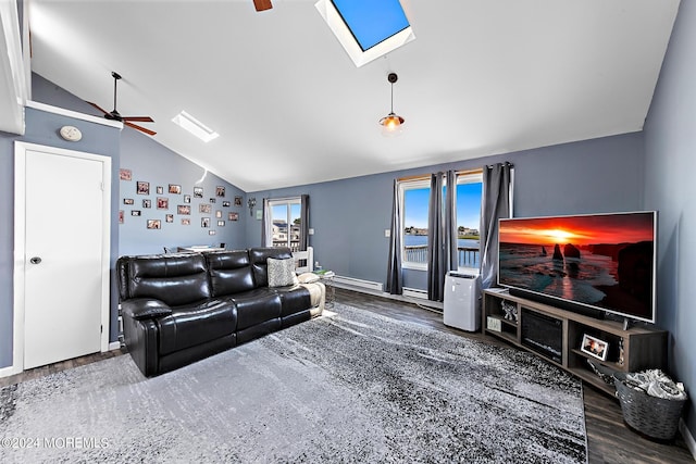 living room with lofted ceiling with skylight, ceiling fan, and dark wood-type flooring