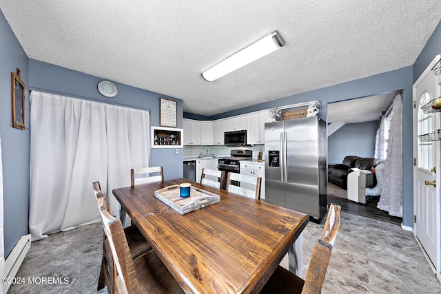 dining area featuring baseboard heating and a textured ceiling