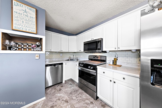 kitchen featuring white cabinetry, a textured ceiling, and appliances with stainless steel finishes