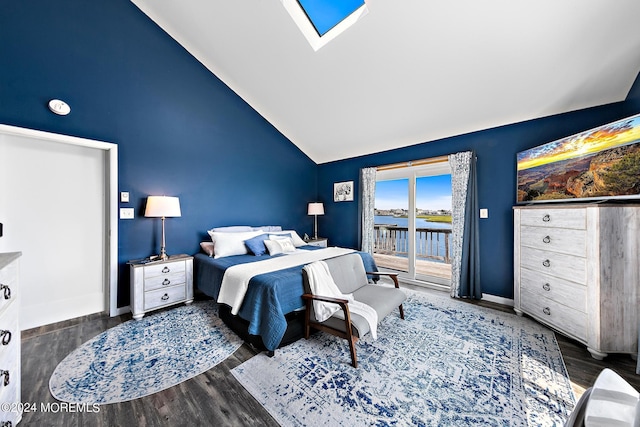 bedroom featuring access to outside, dark wood-type flooring, high vaulted ceiling, and a skylight