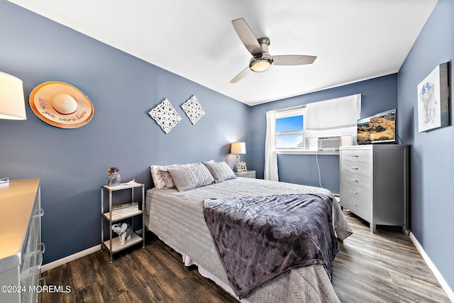 bedroom featuring ceiling fan, dark hardwood / wood-style flooring, and cooling unit