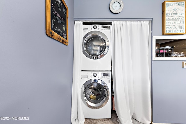 laundry area with stacked washing maching and dryer