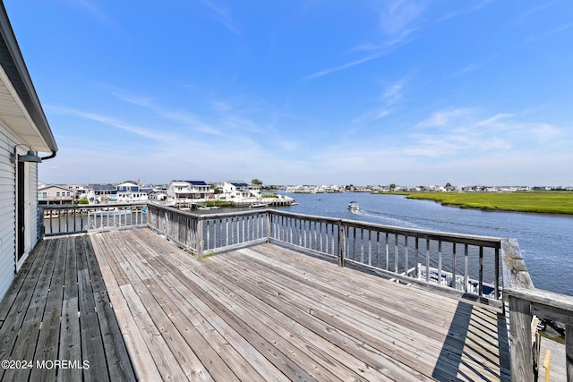 wooden terrace featuring a water view