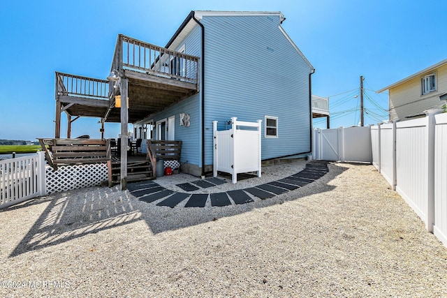 back of house featuring a wooden deck