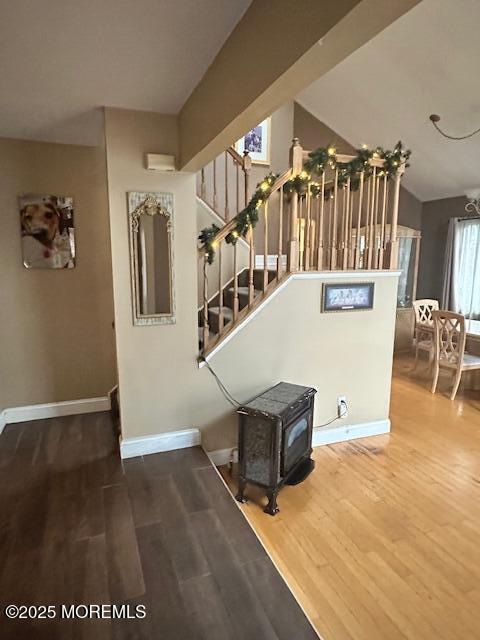 stairs with a chandelier and hardwood / wood-style floors