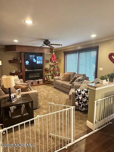 living room featuring ceiling fan, crown molding, and hardwood / wood-style floors