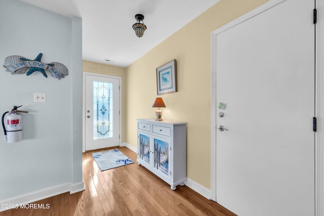 doorway to outside with light wood-type flooring