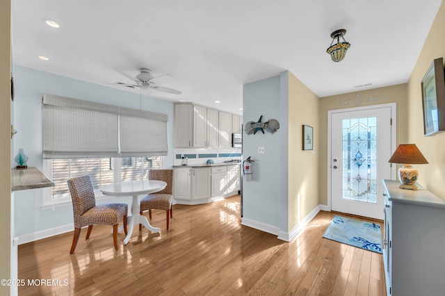 interior space featuring ceiling fan and light wood-type flooring