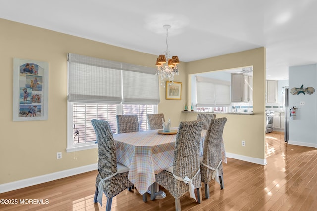 dining space featuring a notable chandelier and light hardwood / wood-style flooring