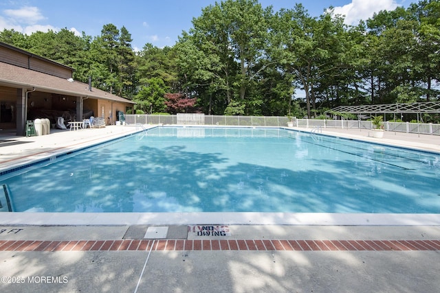 view of swimming pool with a patio