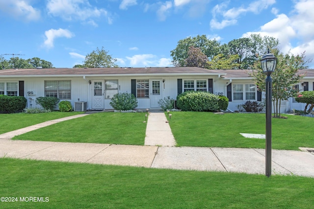 single story home with central AC and a front lawn