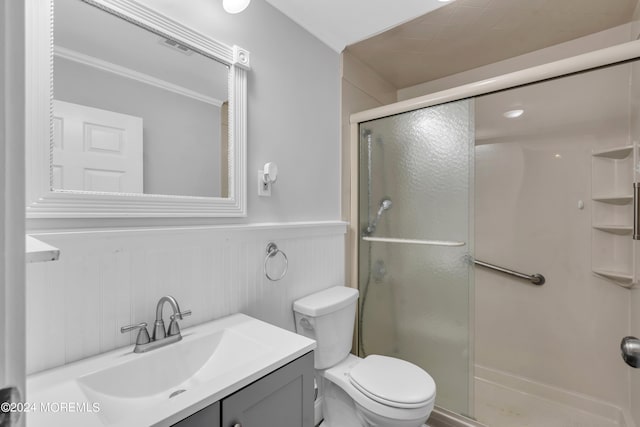 bathroom featuring toilet, an enclosed shower, vanity, and crown molding