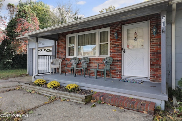 entrance to property featuring a garage and covered porch