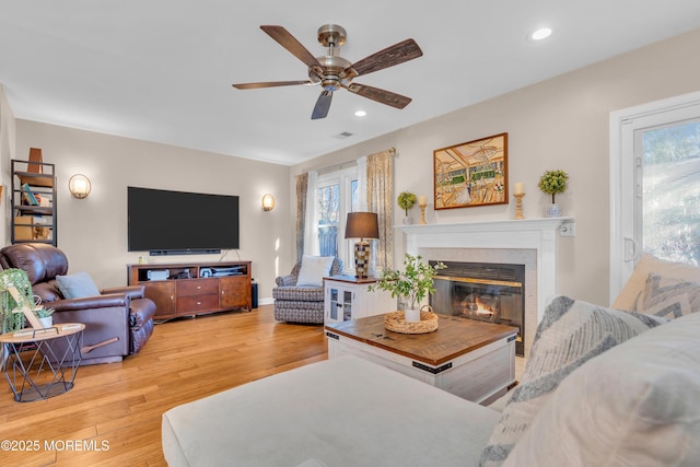 living room featuring ceiling fan and light wood-type flooring