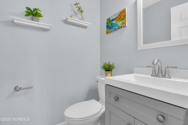 bathroom featuring toilet and vanity