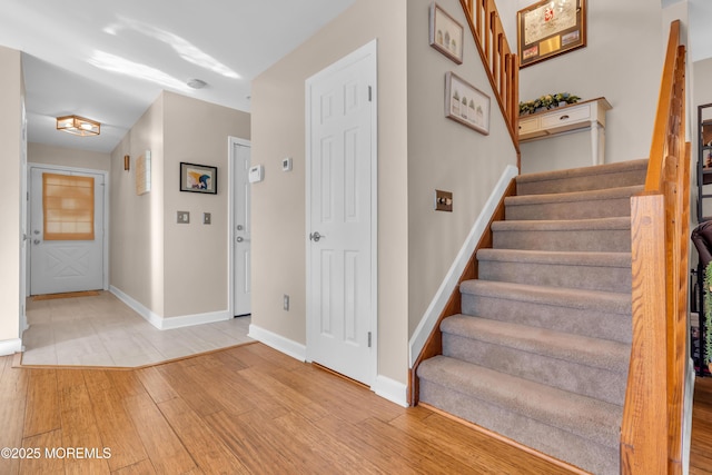 stairs with wood-type flooring