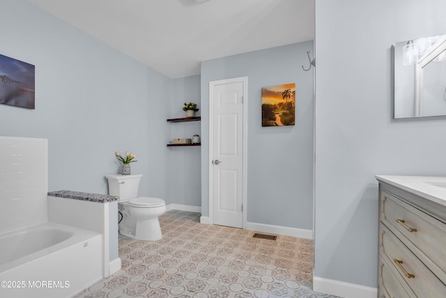 bathroom featuring toilet and vanity