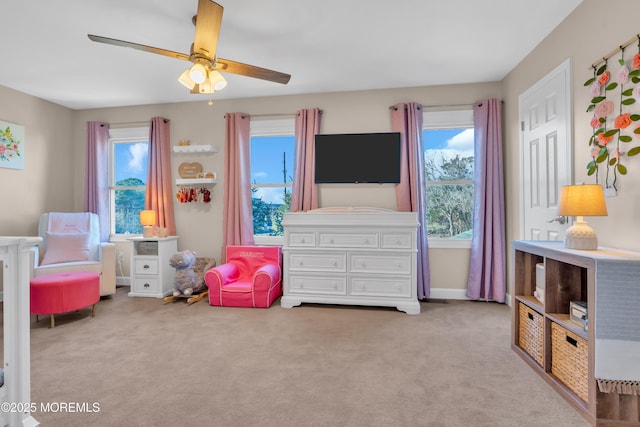 game room featuring light carpet and ceiling fan