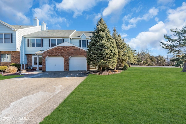 view of front of home with a front lawn and a garage