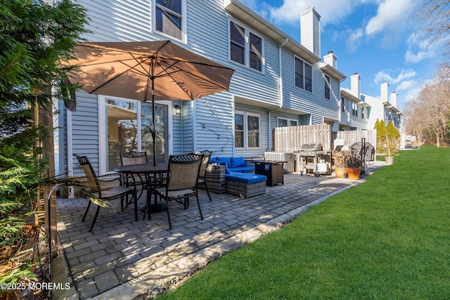 back of property featuring a yard and a patio