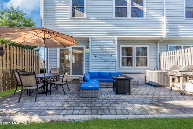 view of patio featuring central AC, an outdoor living space with a fire pit, and area for grilling