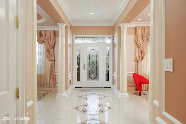 tiled entrance foyer with crown molding and ornate columns