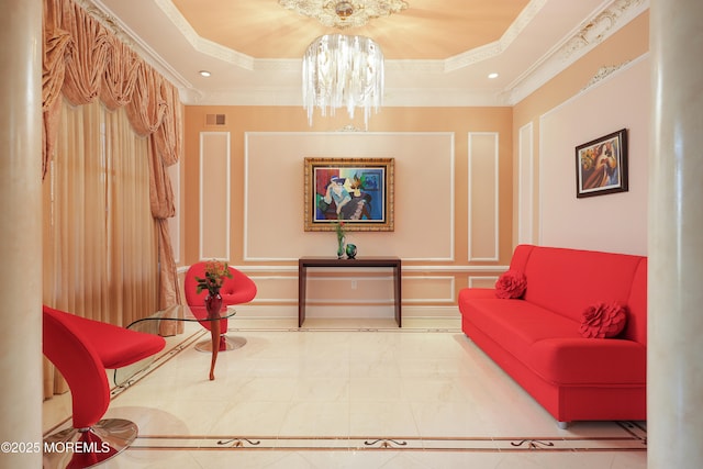 living area featuring ornamental molding, a raised ceiling, and a chandelier