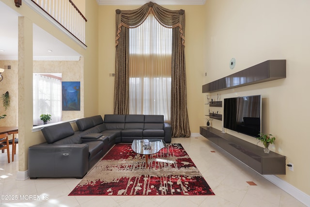 living room with a wealth of natural light, ornamental molding, and light tile patterned flooring