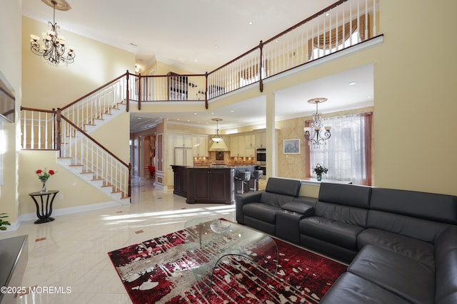 tiled living room with a high ceiling and a chandelier