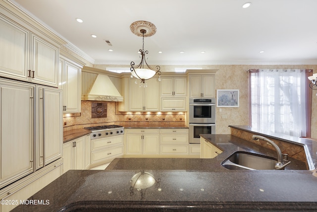 kitchen with sink, stainless steel double oven, gas stovetop, and cream cabinets