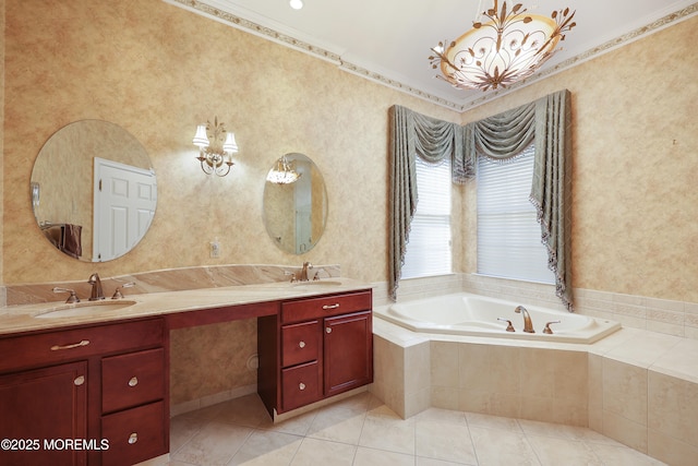 bathroom featuring tile patterned flooring, crown molding, tiled tub, and vanity