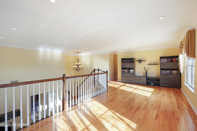 corridor featuring light hardwood / wood-style flooring and ornamental molding