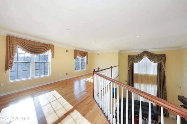 hall with crown molding and light hardwood / wood-style floors