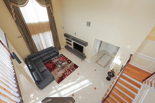 tiled living room with a high ceiling