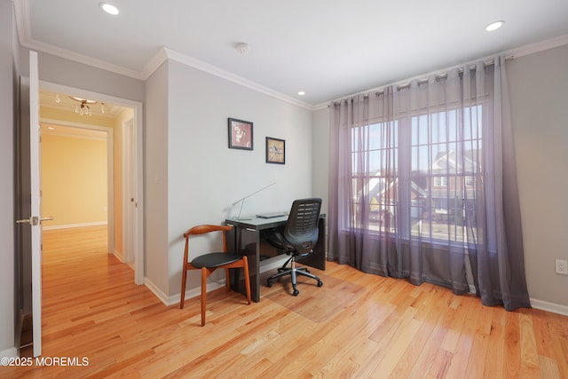 home office with light hardwood / wood-style floors and ornamental molding