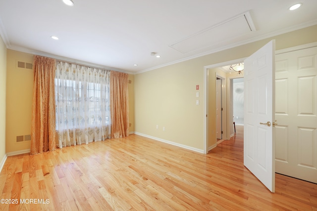 unfurnished room with light wood-type flooring and ornamental molding