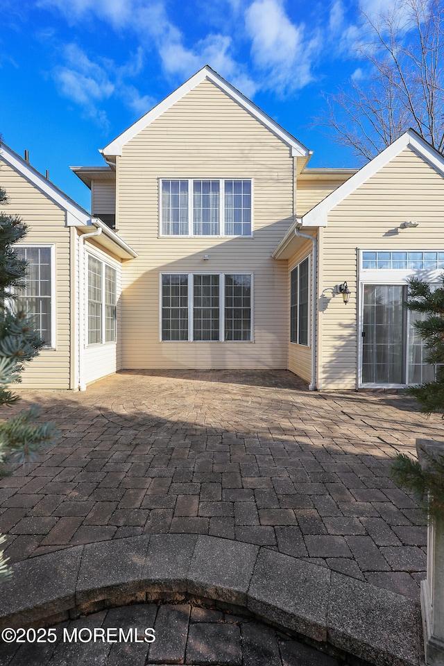 rear view of property featuring a patio