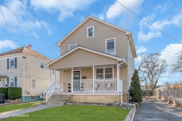 front of property with a front yard and covered porch