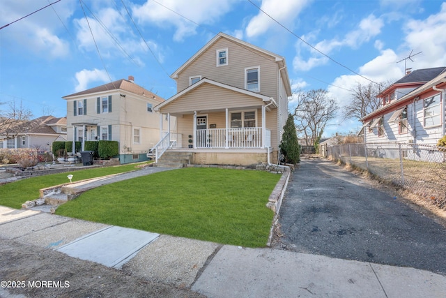 view of front of property featuring a front lawn and a porch