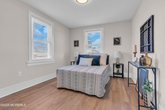 bedroom featuring hardwood / wood-style flooring and multiple windows