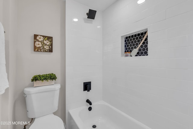 bathroom with toilet and tiled shower / bath combo