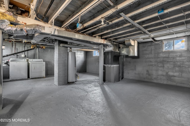 basement featuring washer and dryer, heating unit, and gas water heater