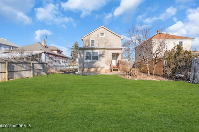 rear view of house featuring a yard